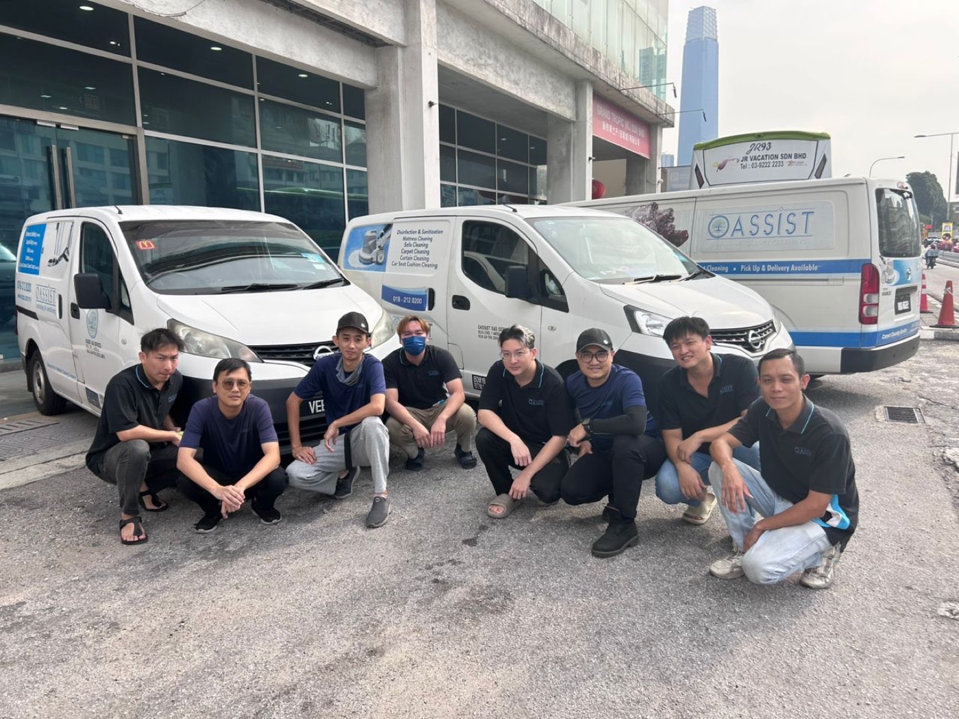 The Oassist crew with their branded service fleet